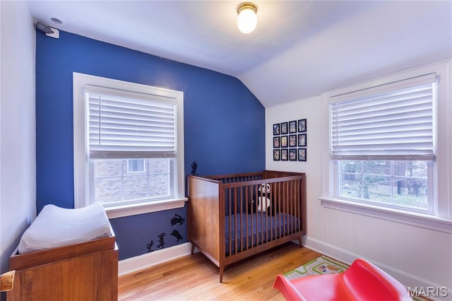 1076 N Jackson Ave, University City, MO 63130 - bedroom featuring wood finished floors and lofted ceiling
