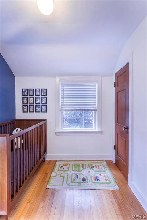 1076 N Jackson Ave, University City, MO 63130 - corridor with wood finished floors and vaulted ceiling