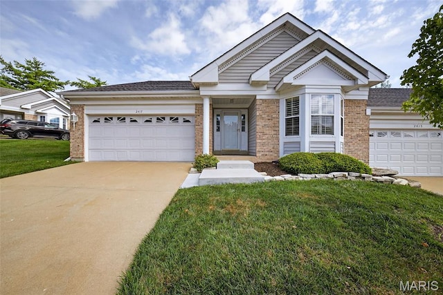 2417 S Lakeridge Ct Unit 14, Lake St Louis, MO 63367 - view of front of house with brick siding, an attached garage, concrete driveway, and a front lawn