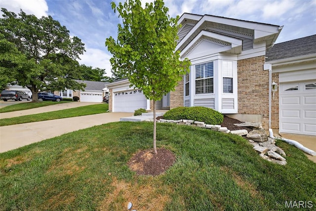 2417 S Lakeridge Ct Unit 14, Lake St Louis, MO 63367 - view of front of house with a front yard, brick siding, concrete driveway, and a garage