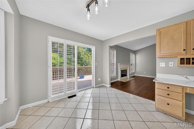 2417 S Lakeridge Ct Unit 14, Lake St Louis, MO 63367 - unfurnished dining area with a fireplace with flush hearth and light tile patterned floors