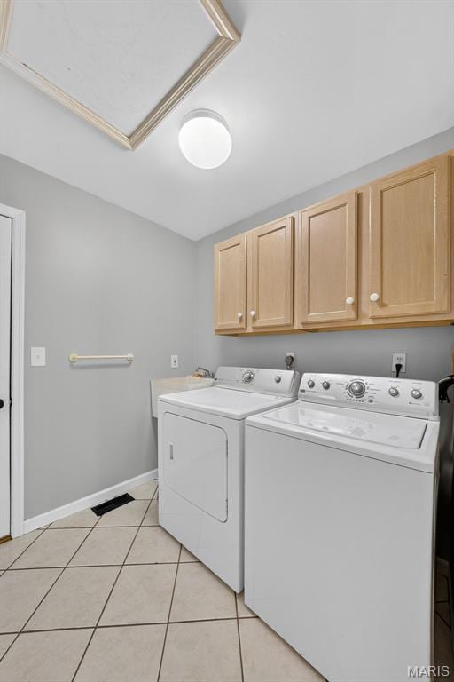 2417 S Lakeridge Ct Unit 14, Lake St Louis, MO 63367 - laundry room with cabinet space, washing machine and dryer, and light tile patterned floors