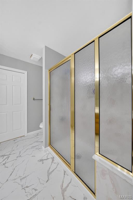 2417 S Lakeridge Ct Unit 14, Lake St Louis, MO 63367 - bathroom featuring a shower with door and marble finish floors