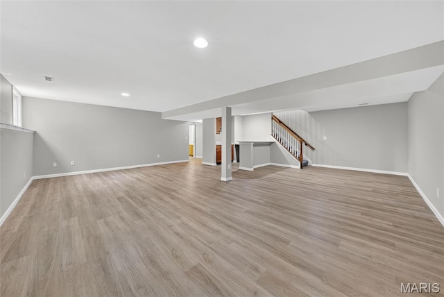 2417 S Lakeridge Ct Unit 14, Lake St Louis, MO 63367 - finished below grade area featuring light wood finished floors, recessed lighting, and stairway