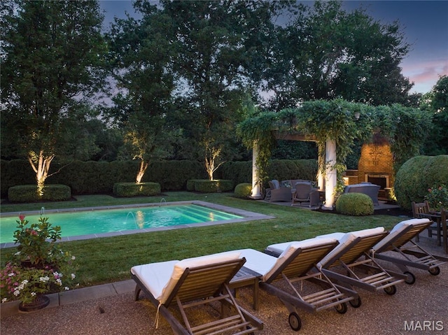 10420 Litzsinger Rd, Frontenac, MO 63131 - view of swimming pool with a fireplace, a patio area, and a lawn