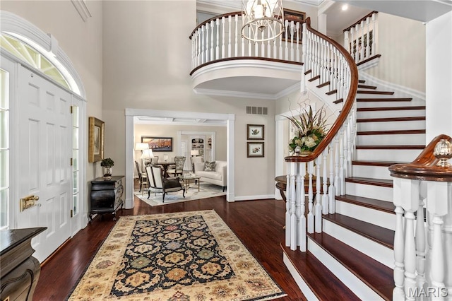 10420 Litzsinger Rd, Frontenac, MO 63131 - entrance foyer with dark wood-style floors, stairs, a high ceiling, ornamental molding, and a chandelier