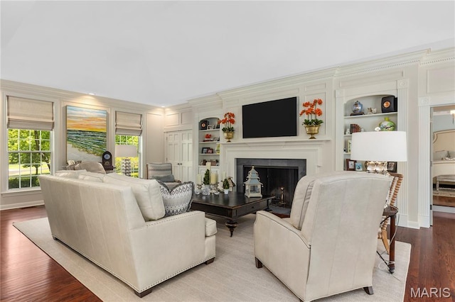 10420 Litzsinger Rd, Frontenac, MO 63131 - living room featuring a fireplace, wood finished floors, and built in features