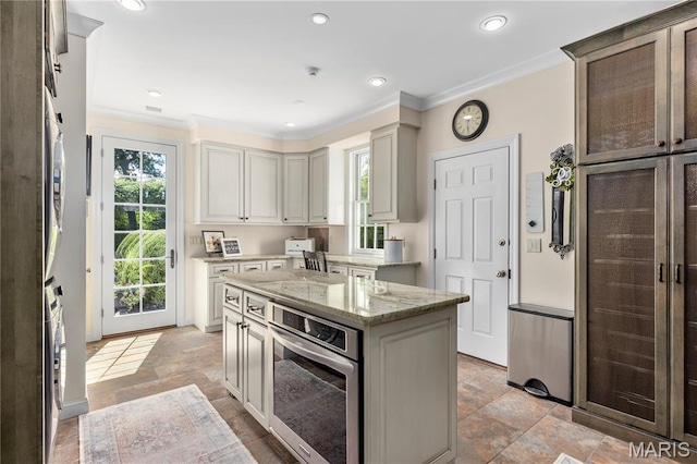 10420 Litzsinger Rd, Frontenac, MO 63131 - kitchen featuring oven, light stone finish floors, crown molding, a center island, and light stone counters