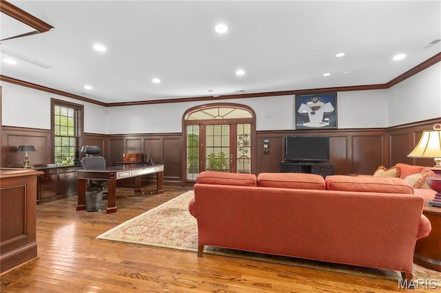 10420 Litzsinger Rd, Frontenac, MO 63131 - living area featuring a decorative wall, ornamental molding, wainscoting, plenty of natural light, and wood finished floors