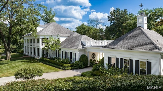 10420 Litzsinger Rd, Frontenac, MO 63131 - view of front facade featuring roof with shingles and a front yard
