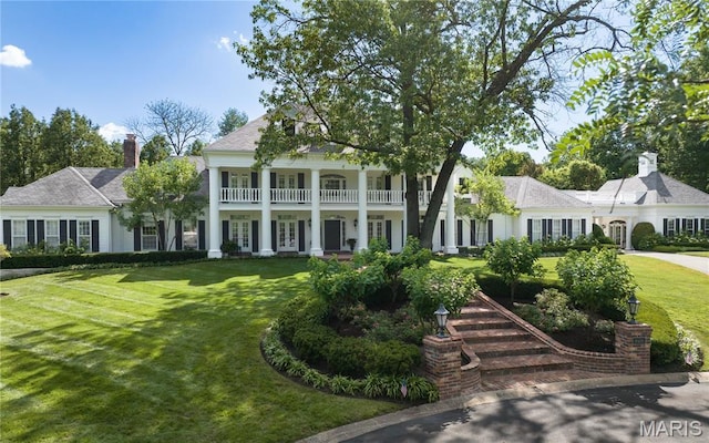 10420 Litzsinger Rd, Frontenac, MO 63131 - neoclassical / greek revival house featuring a front lawn and a chimney