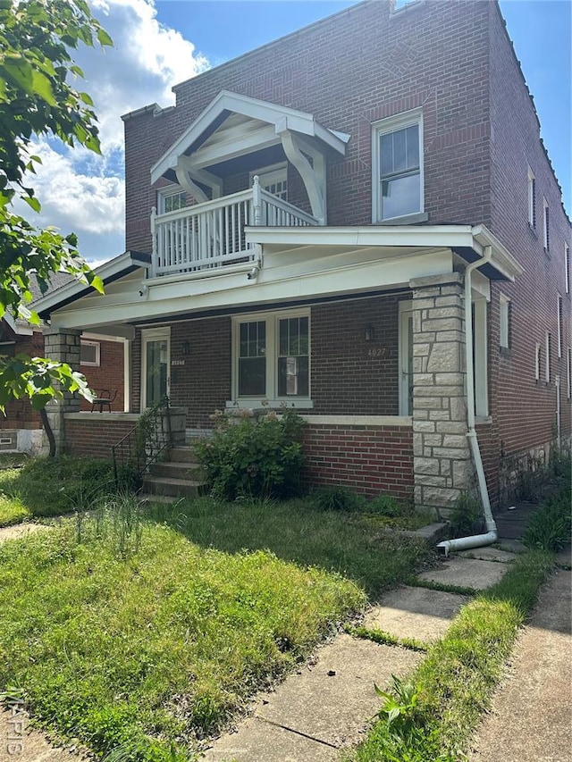 4027 Bamberger Ave, Saint Louis, MO 63116 - view of front of home featuring a balcony, a porch, and brick siding
