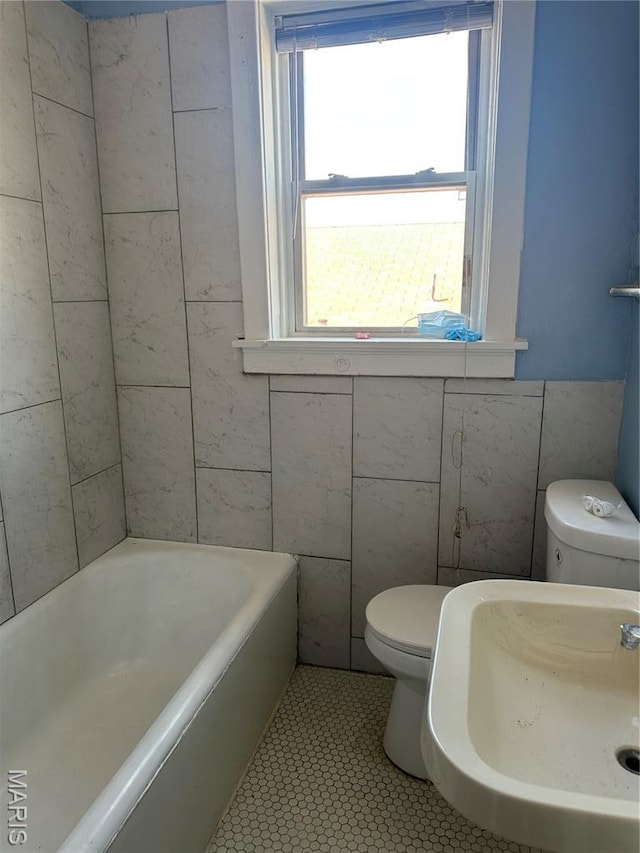 4027 Bamberger Ave, Saint Louis, MO 63116 - full bathroom featuring tile walls, a tub to relax in, and tile patterned flooring