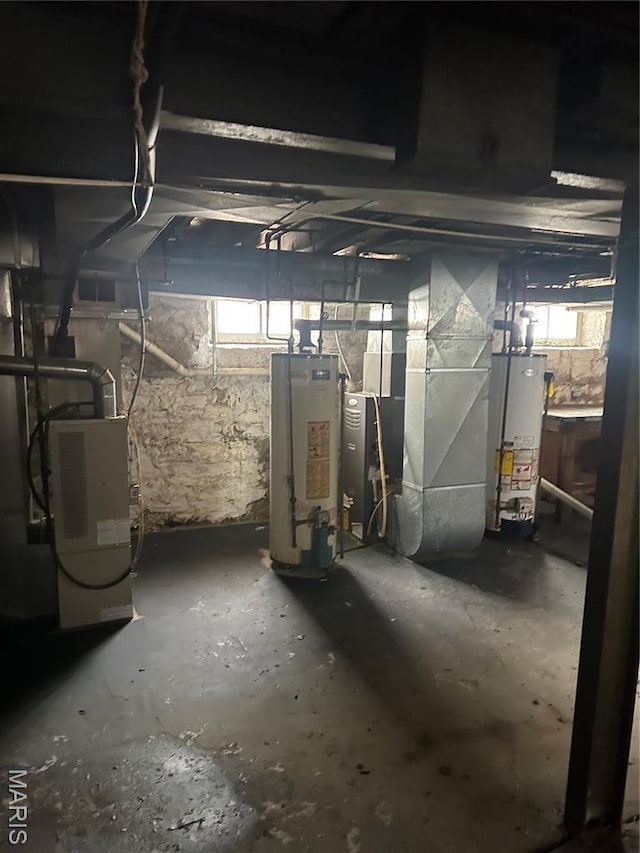 4027 Bamberger Ave, Saint Louis, MO 63116 - basement featuring water heater, heating unit, and plenty of natural light