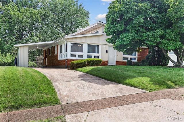 7944 Westover Pl, University City, MO 63130 - view of front of home with concrete driveway, brick siding, a front lawn, and a carport