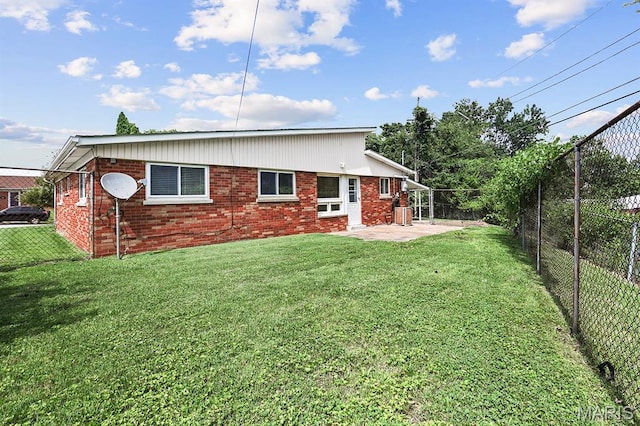 7944 Westover Pl, University City, MO 63130 - back of property featuring a fenced backyard, brick siding, and a patio area
