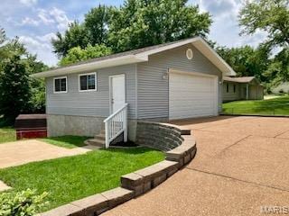 2301 Arkansas Dr, High Ridge, MO 63049 - view of front of property featuring a garage, a front lawn, and driveway