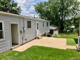 2301 Arkansas Dr, High Ridge, MO 63049 - back of property featuring a lawn and a patio area