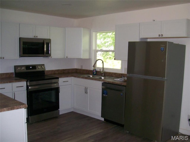 243 Jones St, Sullivan, MO 63080 - kitchen with stainless steel appliances, white cabinets, dark countertops, and dark wood-style flooring
