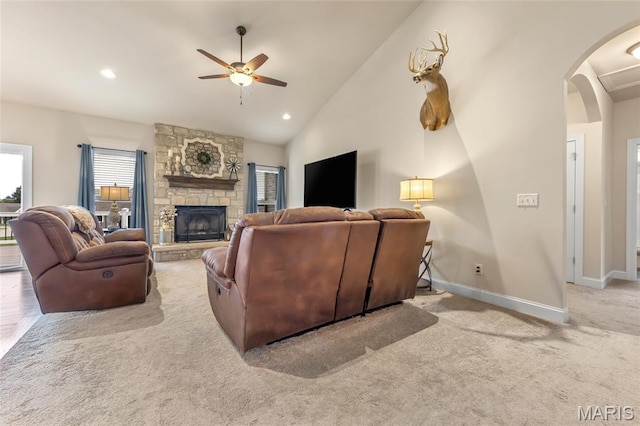 222 Austin Oaks Dr, Moscow Mills, MO 63362 - carpeted living room with a ceiling fan, arched walkways, vaulted ceiling, a fireplace, and recessed lighting