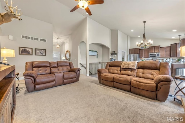 222 Austin Oaks Dr, Moscow Mills, MO 63362 - living room with light colored carpet, a chandelier, ceiling fan, high vaulted ceiling, and recessed lighting