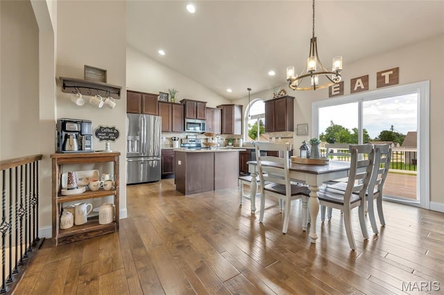 222 Austin Oaks Dr, Moscow Mills, MO 63362 - dining room with a chandelier, hardwood / wood-style floors, recessed lighting, and high vaulted ceiling