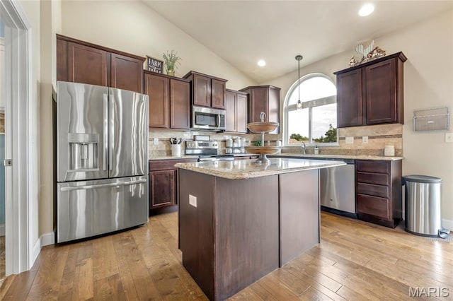 222 Austin Oaks Dr, Moscow Mills, MO 63362 - kitchen featuring stainless steel appliances, light wood-type flooring, backsplash, dark brown cabinetry, and vaulted ceiling