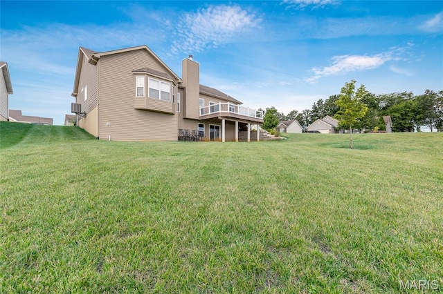 222 Austin Oaks Dr, Moscow Mills, MO 63362 - back of property with a lawn, a wooden deck, and a chimney