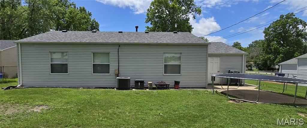 28 Steeplechase Dr, Saint Peters, MO 63376 - back of property with a trampoline, a yard, and roof with shingles