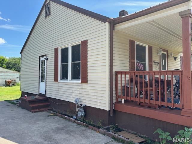 929 Lake St, Sikeston, MO 63801 - view of property exterior with a chimney
