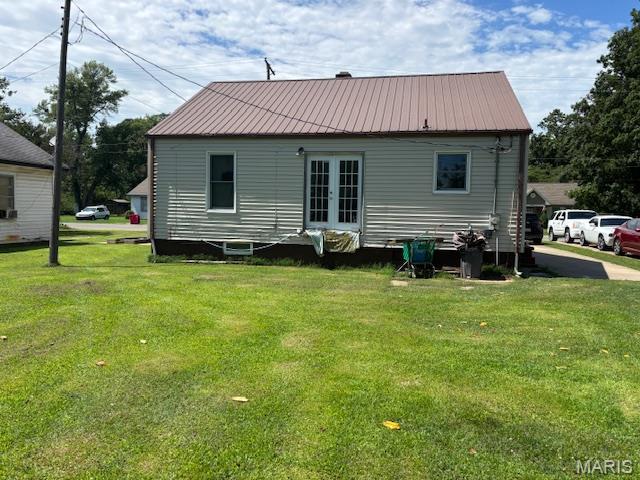 929 Lake St, Sikeston, MO 63801 - rear view of house with a lawn, french doors, and a metal roof