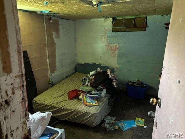929 Lake St, Sikeston, MO 63801 - bedroom featuring concrete block wall and concrete flooring