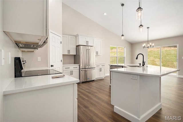 684 Fox Creek Dr, Fenton, MO 63026 - kitchen with high end fridge, range, light countertops, dark wood finished floors, and an island with sink