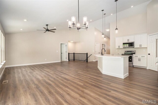 684 Fox Creek Dr, Fenton, MO 63026 - kitchen with stainless steel appliances, ceiling fan, open floor plan, light countertops, and white cabinets