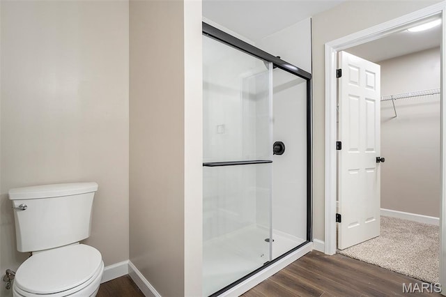 684 Fox Creek Dr, Fenton, MO 63026 - bathroom featuring a shower stall, wood finished floors, and a spacious closet