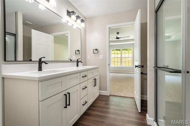 684 Fox Creek Dr, Fenton, MO 63026 - bathroom with ceiling fan, double vanity, and wood finished floors