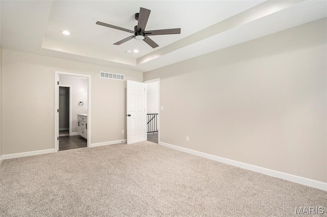684 Fox Creek Dr, Fenton, MO 63026 - unfurnished bedroom featuring dark colored carpet, a raised ceiling, recessed lighting, connected bathroom, and ceiling fan
