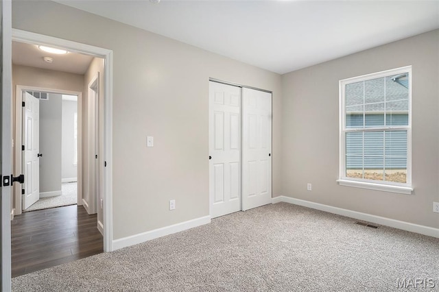 684 Fox Creek Dr, Fenton, MO 63026 - unfurnished bedroom featuring carpet floors, a closet, and wood finished floors
