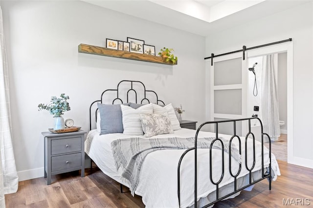 10523 Village Ln, Foristell, MO 63348 - bedroom with a barn door and wood finished floors