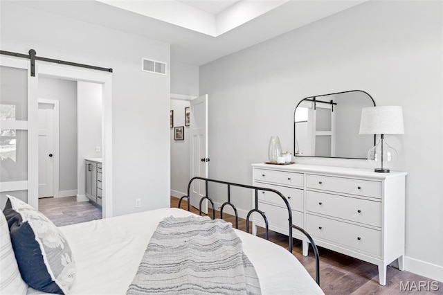 10523 Village Ln, Foristell, MO 63348 - bedroom featuring wood finished floors, a barn door, and ensuite bath