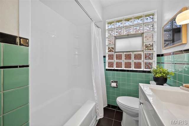 5021 Hi View Ave, Shrewsbury, MO 63119 - full bath with tile patterned flooring, tile walls, vanity, shower / bathtub combination with curtain, and a wainscoted wall