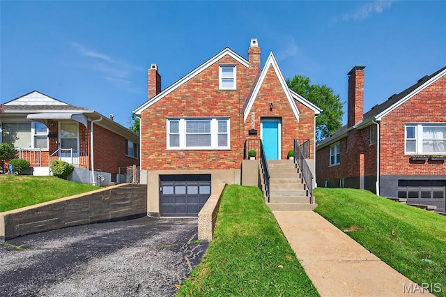 5021 Hi View Ave, Shrewsbury, MO 63119 - tudor home with a garage, asphalt driveway, a chimney, and a front lawn