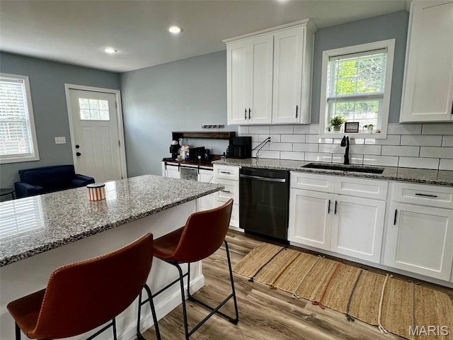 320 N Dickerson St, Palmyra, MO 63461 - kitchen with dishwasher, light wood finished floors, recessed lighting, decorative backsplash, and white cabinets