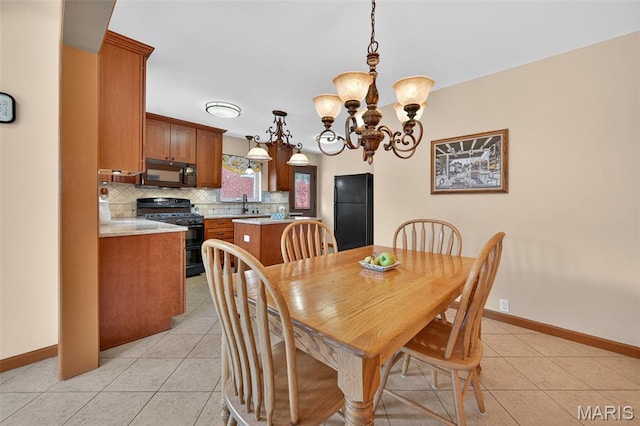 6580 Oleatha Ave, Saint Louis, MO 63139 - dining area with light tile patterned flooring and a chandelier