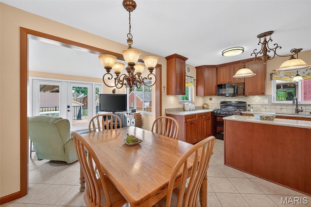 6580 Oleatha Ave, Saint Louis, MO 63139 - dining space featuring light tile patterned flooring, french doors, and healthy amount of natural light