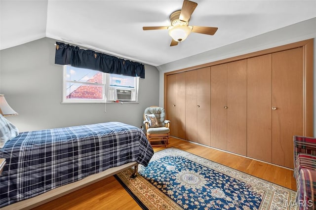 6580 Oleatha Ave, Saint Louis, MO 63139 - bedroom with cooling unit, light wood-style flooring, a closet, vaulted ceiling, and a ceiling fan
