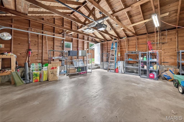 6580 Oleatha Ave, Saint Louis, MO 63139 - garage featuring wooden walls and a garage door opener