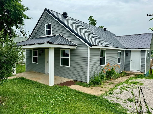 401 Clara St, Potosi, MO 63664 - back of house with a lawn, a metal roof, and a patio area