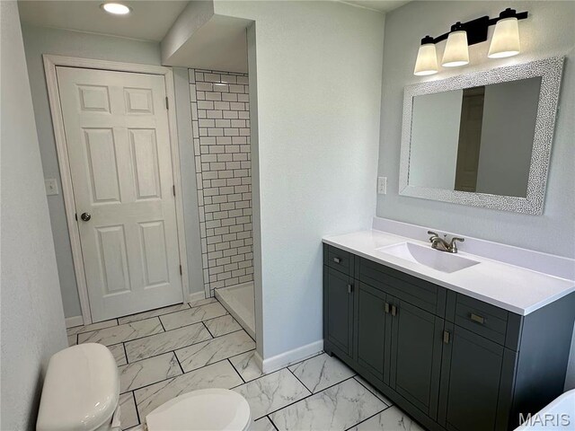 401 Clara St, Potosi, MO 63664 - bathroom with marble finish floors, vanity, a tile shower, and recessed lighting