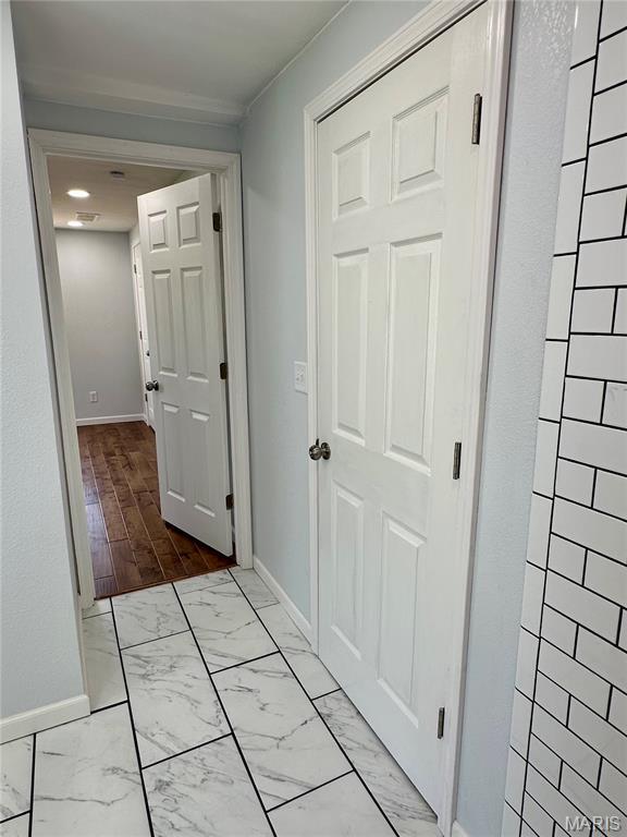401 Clara St, Potosi, MO 63664 - hall with baseboards and marble look tiles